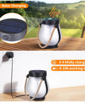 Two Pack Solar Flame Lantern Lights With Flickering Flame Effect for a Lit Outdoor Look on wood table and wall plug