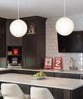 Mid Century Modern Globe Pendant Light With Frosted Glass Orb, White Finish, Minimalist Hanging Lamp in a modern kitchen