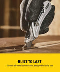 Hand using Sport Knife With Easy Blade Change And One Handed Quick Slide Blade Slider Takes Standard Utility Blades Safety Feature Prevents Dual Blades Two And Seven Sixteenth Inch Blade Five And Quarter Inch Handle Silver Finish on wood surface