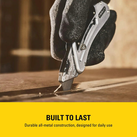 Hand using Sport Knife With Easy Blade Change And One Handed Quick Slide Blade Slider Takes Standard Utility Blades Safety Feature Prevents Dual Blades Two And Seven Sixteenth Inch Blade Five And Quarter Inch Handle Silver Finish on wood surface
