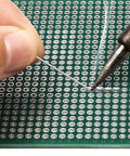 Hand soldering on 72x100mm DIN Rail Mount PCB Board for Arduino DIY Projects with easy soldering insulated holes and dual pitch terminals.