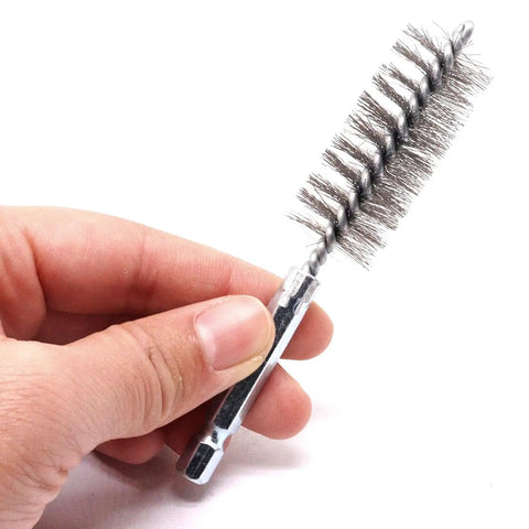 Hand holding stainless steel bore brush from Stainless Steel Bore Brush Set Two Pack With Three Quarter Inch Hex Shank Twisted Round Wire Brushes