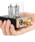 Hand holding Dope U10 Mini Tube Headphone Amplifier For Home Audio HiFi Stereo Preamp with dual jacks