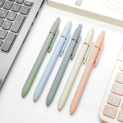 Five Pack Gel Pens 0.5mm Fine Point Black Ink With Super Soft Grip For Smooth Writing Ideal For Journaling And Note Taking Everyday Office School Supplies Gift For Women And Men Morandi Color Set arranged on a desk