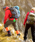 Two hikers with backpacks using Scuba Dive Signal Light With Flashing And Constant Modes High Visibility 360 Degree Underwater Marker Beacon For Night Dives Mini Tank Light For Underwater Safety Green attached to gear.