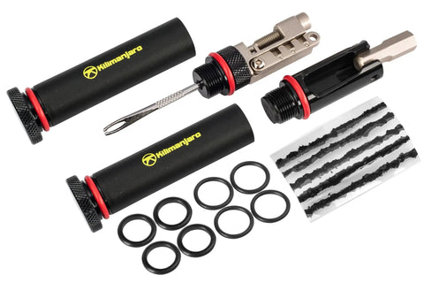 Compact Bar End Bicycle Tool Kit With Chain Tool Spoke Wrench Tire Plugs Hex Torx And Phillips Bits displayed with components