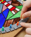 Solid Game Changing Flexible Silicone Layout Blocks 12 Pack With Push Pins, showing a hand placing a push pin in stained glass layout.