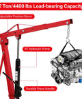 Pro 2 Ton Hydraulic Engine Hoist 4400 Lb Folding Shop Crane with adjustable boom lifting an engine, showing hydraulic pump and handle.