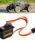 Tough As Nails Micro Servo Motor Kit With Full Metal Gears And Whisper Quiet Operation, showing black servo with wires, ideal for RC vehicles.
