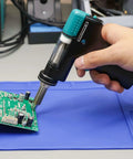 Hand holding Replacement Desoldering Suction Gun Handpiece for 948D Series Desoldering Stations 948D-I III IV V on circuit board