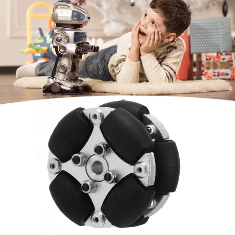 38mm omnidirectional wheel with metal hub and black rollers; background shows a small robot toy on the floor