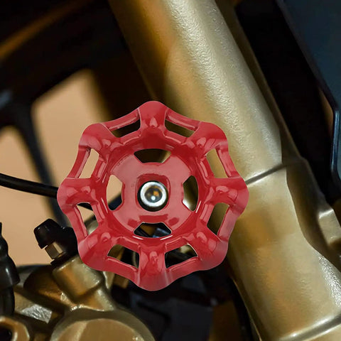 Red metal wheel handle on installed faucet valve