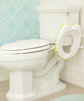 No Fuss Toddler Potty Training Seat With Rock Solid Non Slip Base Secure Handgrips And Quick Wipe Plastic Body For Smooth Potty Learning Journey In Bright Green on a toilet.