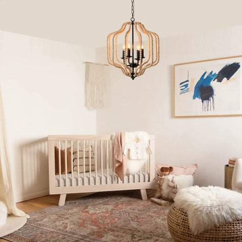 Wood Beaded Chandelier With Four Candle Style Lights For A Cozy Farmhouse Boho Vibe in a nursery with crib and decor