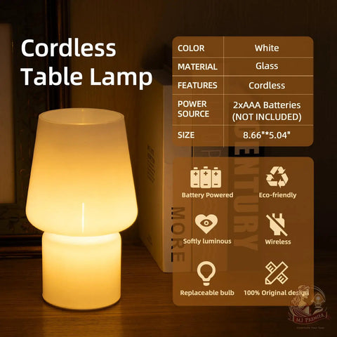 Cordless Battery Operated LED Table Lamp With Opal Cream Glass Shade on a tabletop glowing softly in dark room