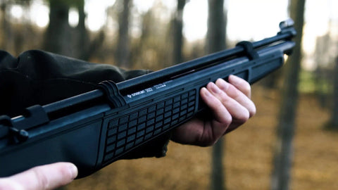 Close-up holding 22 Caliber PCP Air Rifle With Hand Pump, All Weather Synthetic Stock, Rifled Steel Barrel, 700 FPS