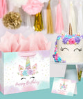 13 Inch Unicorn Birthday Gift Bag with Card and Tissue Paper for Baby Girls and Kids Birthday Bash next to unicorn cake