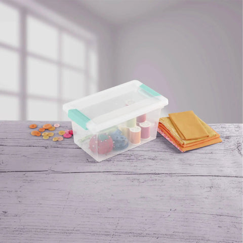 Sixteen Pack Clip Boxes Stackable Clear Plastic Storage Bins With Latching Lids containing craft supplies on a tabletop.