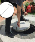 Person using 15.15 Inch Stainless Steel Manhole Cover Hook With T Handle Beefy Heavy Duty Lift Hook Tool for lifting manhole cover