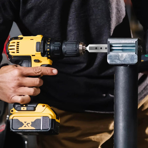 Person using Heavy Duty Trailer Jack Drill Adapter With One Inch Drive Shaft on a cordless drill for easy lifting.