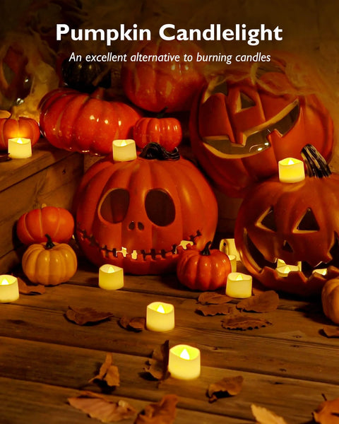 Flameless LED tea lights (24 pcs) glow around carved pumpkins on a wooden table for Halloween centerpiece