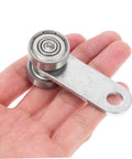 Heavy Duty Sliding Door Roller Wheels With Dual Bearing Iron Groove Caster shown in hand, durable steel design for smooth operation.