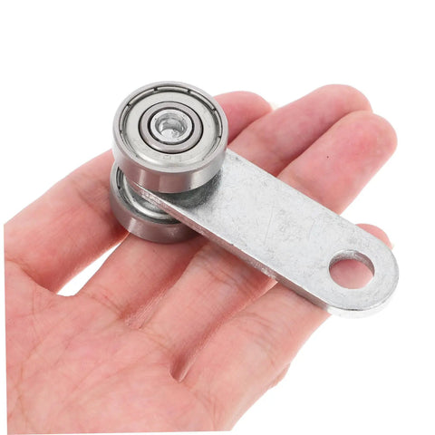 Heavy Duty Sliding Door Roller Wheels With Dual Bearing Iron Groove Caster shown in hand, durable steel design for smooth operation.