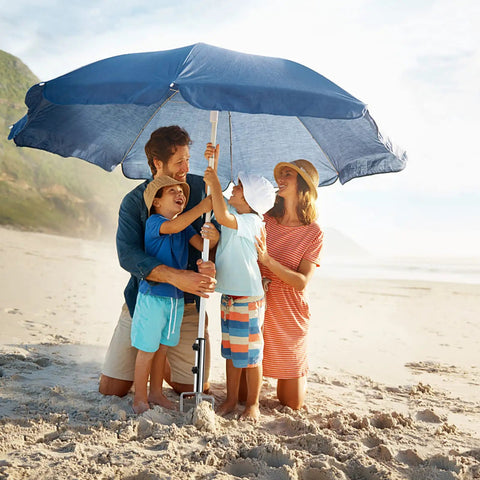 Family using Removable Portable Umbrella Base With Four Leg Beach Sand Anchor Heavy Duty Metal Sun Holder on a sandy beach