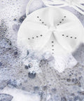 Travel Ready Compact Washing Machine Acts As A Laundry Game Changer By Delivering A Gentle Hand Feel Wash For Underwear Delicates And Light Fabrics Quick Spin Dry Keeps Road Trips Stress Free, shown in soapy water.