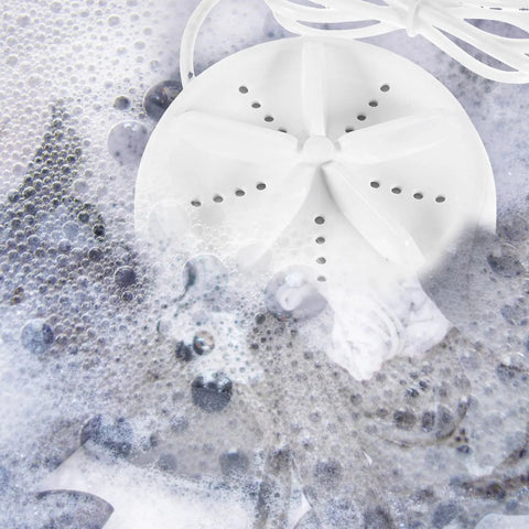 Travel Ready Compact Washing Machine Acts As A Laundry Game Changer By Delivering A Gentle Hand Feel Wash For Underwear Delicates And Light Fabrics Quick Spin Dry Keeps Road Trips Stress Free, shown in soapy water.