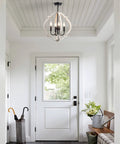 Farmhouse Orb Wood Chandelier 4 Light Pendant for dining room, living room, rustic hanging light fixture, in a foyer entryway.