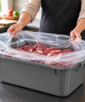Person holding 12 Pack Meat Lug Liners Disposable LDPE Bags For 4.6 To 7 Gallon Totes And 50 Pound Boxes with meat inside