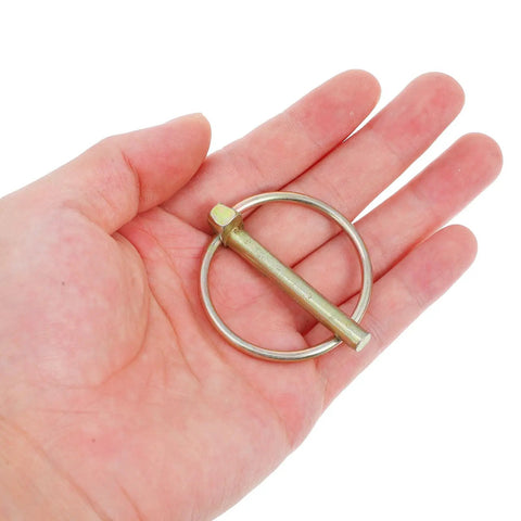 Get Your Yard Gear Fixin' With These 12 Heavy Duty Carbon Steel Retaining Pins Featuring Ring Locks For Tractors Mowers And Trailers To Keep Everything Secure And Rust-Free In The Dirt, shown in hand.