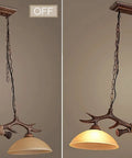 Rustic Retro Two Light Chandelier With Hand Dyed Resin Antlers On Frosted Glass Bowl, on and off view for kitchen dining lighting.