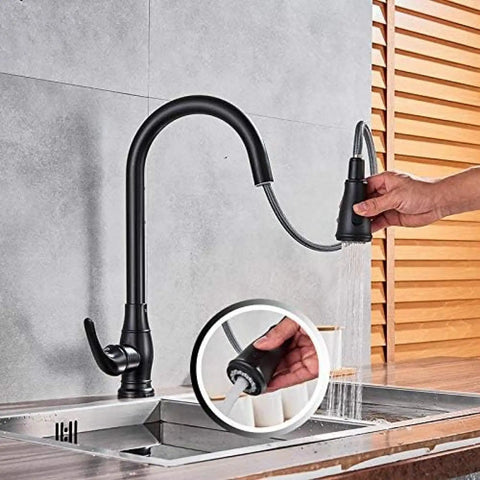 OGMOYT Matte Black Sensor Kitchen Faucet Sensitive Smart Touch Single Handle Mixer Tap with a sprayer in use.