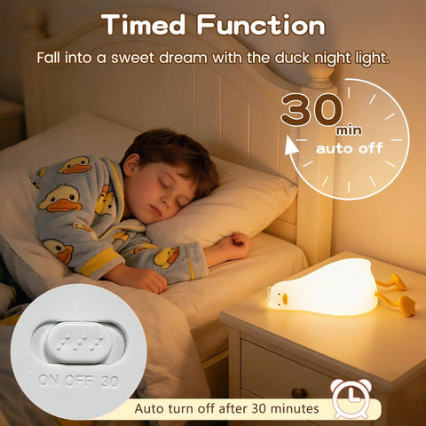 Child sleeping peacefully beside Squishy Silicone Rubber Duck Night Light For Nursery Baby And Kids Dimmable Rechargeable Touch Led Lamp BPA Free Non Toxic Bedside Light For Breastfeeding Shatterproof Safe Cozy Glow on nightstand