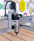Close-up of Shop Ready Heavy Duty 4 Axis 9090 CNC Router For Wood Engraving Milling with spindle and cutting table.