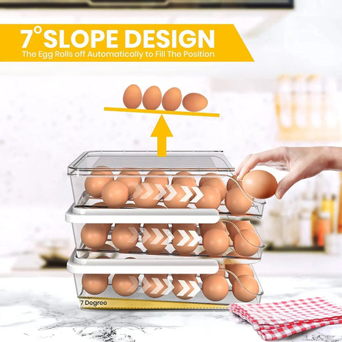 Hand reaching for eggs in a rolling egg tray with lid for fridge, stackable clear egg organizer and dispenser, 3 pack shown in kitchen.