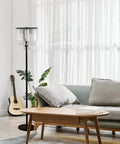 Crystal Floor Lamp With Foot Pedal Dope Modern Standing Light For Living Room Bedroom And Office Black Tall Pole Indoor 3 Light Fixture Elegant Contemporary Decor And Warm Ambience next to a sofa in a bright living room.