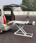 Professional Grade Heavy Duty Workhorse Electric Scissor Lift Table 660 Lb Capacity positioned at van's rear for easy loading.