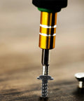 Close-up of a screw being drilled into wood from the 210 Piece Carbon Steel Self Tapping Screws Kit With Washer Pan Head Cross Drive Full Thread M3.0 To M4.8 Black Finish For Cabinets Shelves And General Hardware Use