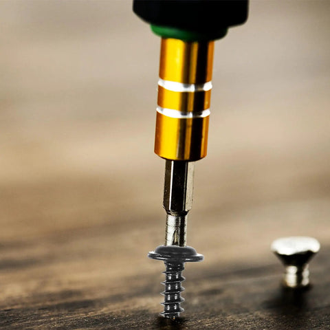 Close-up of a screw being drilled into wood from the 210 Piece Carbon Steel Self Tapping Screws Kit With Washer Pan Head Cross Drive Full Thread M3.0 To M4.8 Black Finish For Cabinets Shelves And General Hardware Use