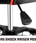 Close-up of gas shock raiser post on black rolling stool with lumbar support for garage use, adjustable height feature visible.