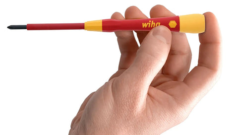 Hand holding a red and yellow insulated precision screwdriver from the Insulated Precision Screwdriver Set 8 Piece PicoFinish Pro Grade.