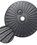 Black water filled umbrella base stand for patio and outdoor use, beefy heavy duty holder with large round base and knobs detail.