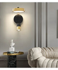 Transform Your Hangout Spot With This Sleek Nordic Iron Wall Sconce above a marble side table, casting warm white glow.