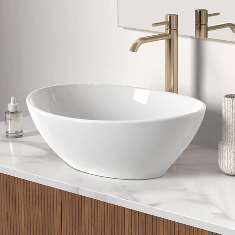 Premium Oval Ceramic Vessel Sink For Bathroom Vanity Countertop Glossy White Porcelain Bowl Above Counter on marble surface.