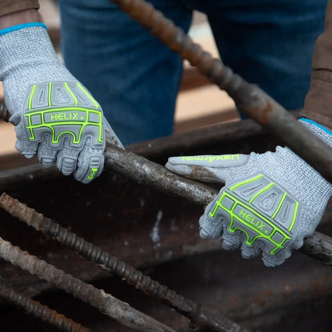 Impact Protection Safety Gloves With Polyurethane Palm Coating A4 Cut Level 13 Gauge Seamless Knit Touchscreen Compatible Helix 1074IMP Large Size Durable Grip For All Day Work, worn by a worker handling metal rods.
