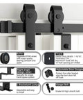 Close-up of Bypass Sliding Barn Door Hardware Kit For Double Doors, showcasing J-shaped rollers and heavy-duty steel track, matte black.