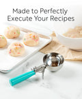 3.25 Ounce Trigger Release Portion Scoop With Green Handle Stainless Steel Disher for cookie dough near baking sheet